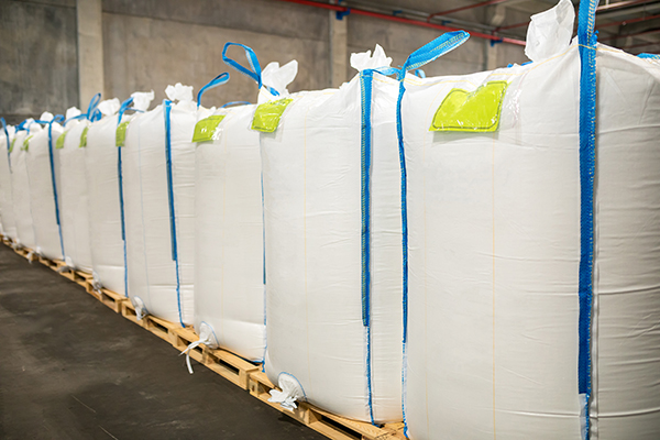 rows,or,stacks,of,white,sack,bags,at,large,warehouse