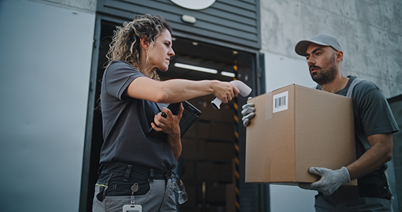 multiethnic,workers,taking,cardboard,boxes,with,online,orders,,e commerce,goods