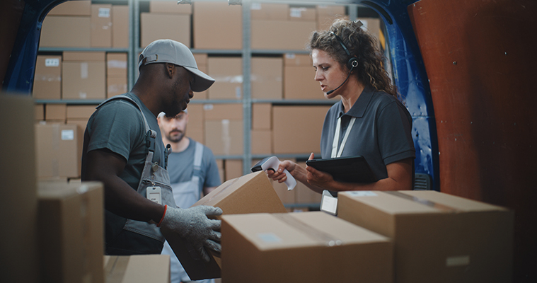 three warehouse workers loading delivery van